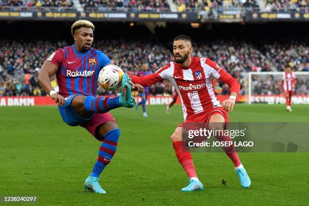 Barcelona's Spanish forward Adama Traore vies with Atletico Madrid's Belgian midfielder Yannick Ferreira-Carrasco during the Spanish league football...