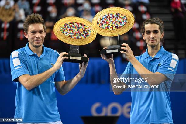 France's Pierre-Hugues Herbert an Nicolas Mahut pose with their winners' trophies after winning the ATP World Tour Open Sud de France doubles final...