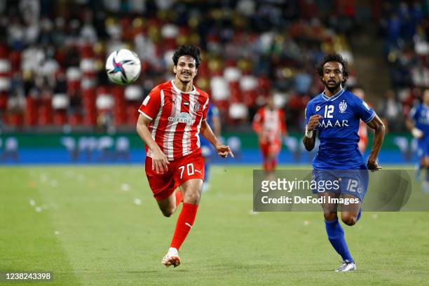 Ahmed Al Hashmi of Al Jazira Club and Yasir Alshahraniof Al Hilal SC battle for the ball during the FIFA Club World Cup UAE 2021 2nd Round match...