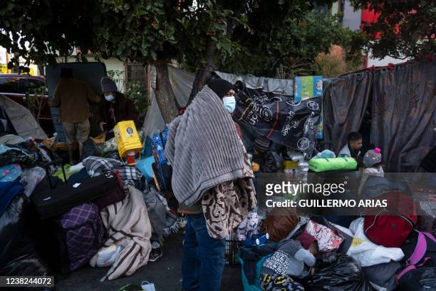 Migrants are seen as authorities dismantle an improvised camp outside El Chaparral crossing port in Tijuana, Baja California state, Mexico, near the...
