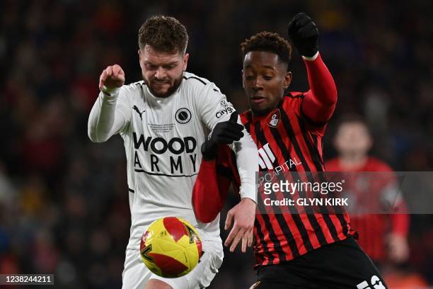 Boreham Wood's English defender Connor Stevens fights for the ball with Bournemouth's Jamaican striker Jamal Lowe during the English FA Cup fourth...