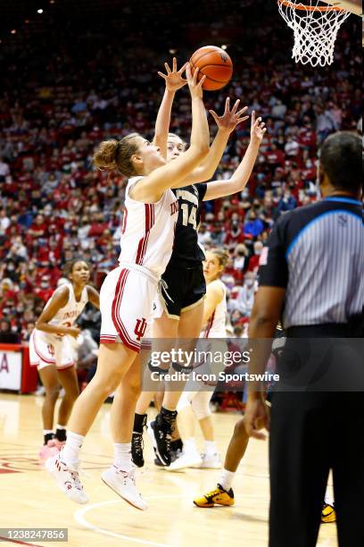 Indiana Hoosiers forward Aleksa Gulbe goes up strong with her shot into Purdue Boilermakers guard Ava Learn during a womens college basketball game...