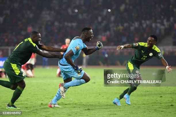 Senegal's players including goalkeeper Edouard Mendy celebrate after winning after the penalty shoot-out as part of the Africa Cup of Nations 2021...