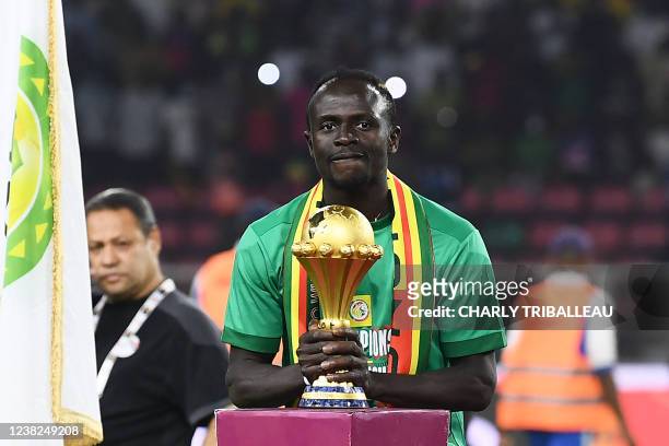 Senegal's forward Sadio Mane holds the trophy prior to the ceremony after winning after the Africa Cup of Nations 2021 final football match between...