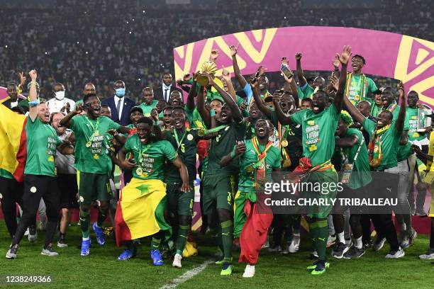 Senegal's players celebrate with the trophy after winning the Africa Cup of Nations 2021 final football match between Senegal and Egypt at Stade...