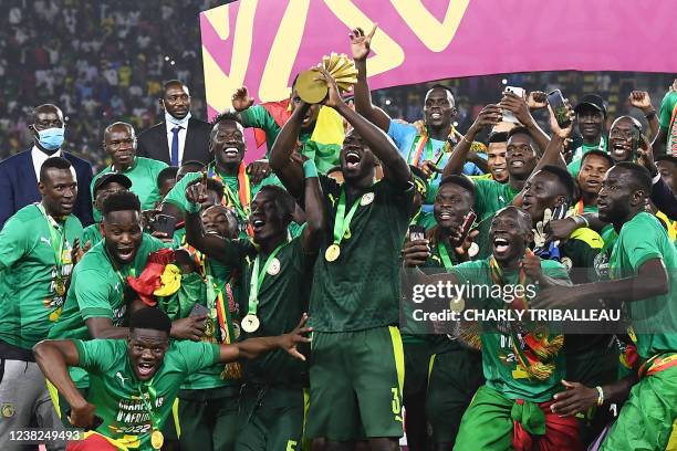 Senegal's players celebrate with the trophy after winning the Africa Cup of Nations 2021 final football match between Senegal and Egypt at Stade...