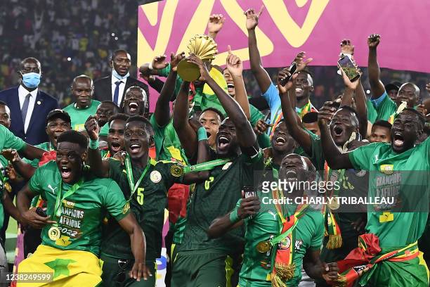 Senegal's players celebrate with the trophy after winning the Africa Cup of Nations 2021 final football match between Senegal and Egypt at Stade...