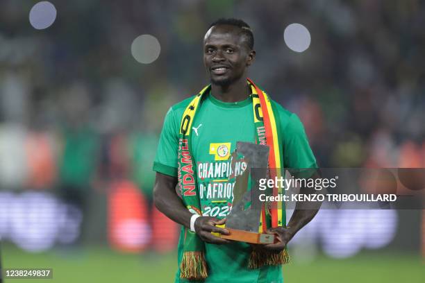 Senegal's forward Sadio Mane poses with the player of the tournament award after winning the Africa Cup of Nations 2021 final football match between...