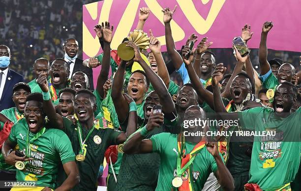 Senegal's players celebrate with the trophy after winning the Africa Cup of Nations 2021 final football match between Senegal and Egypt at Stade...