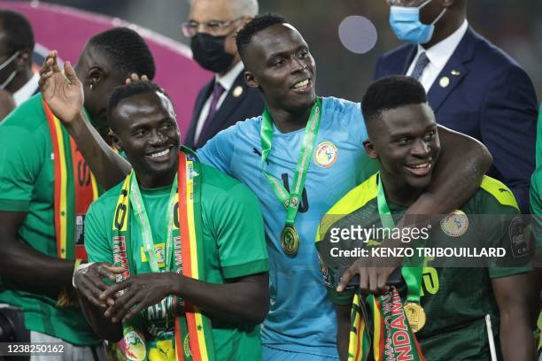 Senegal's forward Sadio Mane, Senegal's goalkeeper Edouard Mendy and Senegal's forward Bamba Dieng celebrate after winning the Africa Cup of Nations...
