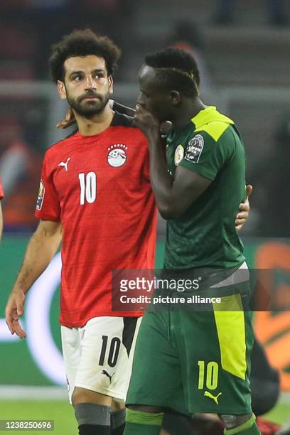 February 2022, Cameroon, Yaounde: Senegal's Sadio Mane consoles Egypt's Mohamed Salah after the 2021 Africa Cup of Nations final soccer match between...
