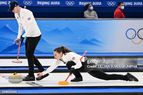 Britain's Jennifer Dodds and Britain's Bruce Mouat curl the stone during the mixed doubles round robin session 13 game of the Beijing 2022 Winter...