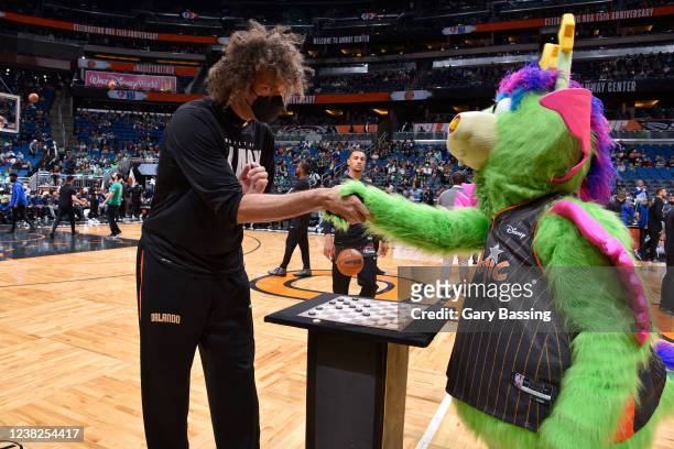 Robin Lopez of the Orlando Magic plays checkers with Stuff the Magic Dragon prior to the game against the Boston Celtics on February 6, 2022 at Amway...