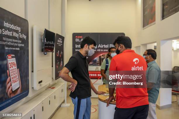 An employee attends to a customer inside a Bharti Airtel Ltd. Store in Mumbai, India, on Saturday, Feb. 5, 2022. Bharti Airtel will release quarterly...