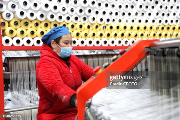 Worker works on an assembly line at a woven bag factory in Lianyun district of Lianyungang city, East China's Jiangsu Province, Feb 7, 2022.