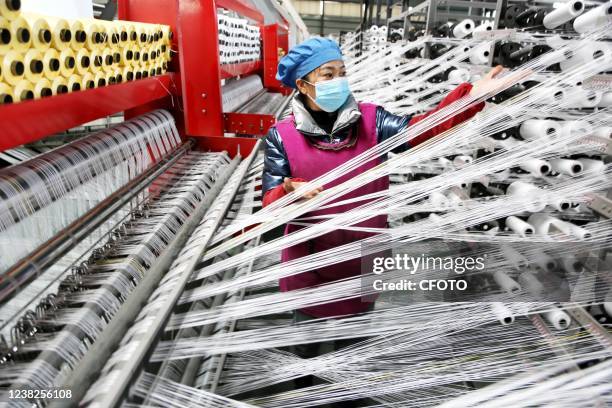 Worker works on an assembly line at a woven bag factory in Lianyun district of Lianyungang city, East China's Jiangsu Province, Feb 7, 2022.