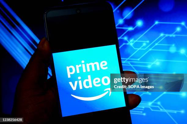 In this photo illustration, an Amazon Prime video logo is displayed on a smartphone screen .