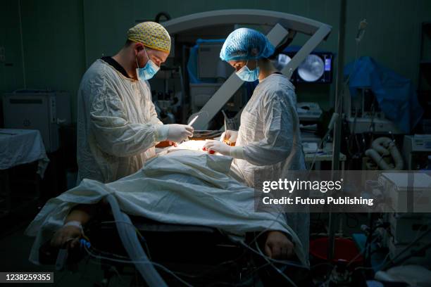 Medics are seen at work in an operating theatre at the Zakarpattia Regional Neurosurgery and Neurology Centre in Uzhhorod, Zakarpattia Region,...