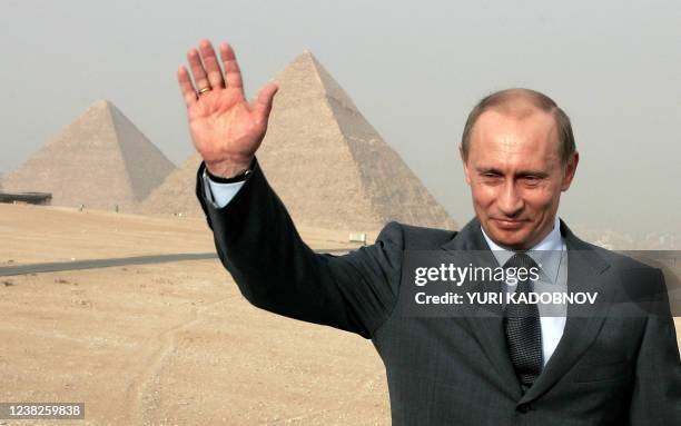 Russian President Vladimir Putin waves as he visits the Pyramids in Cairo, 27 April 2005. President Vladimir Putin arrives in Egypt Tuesday on the...