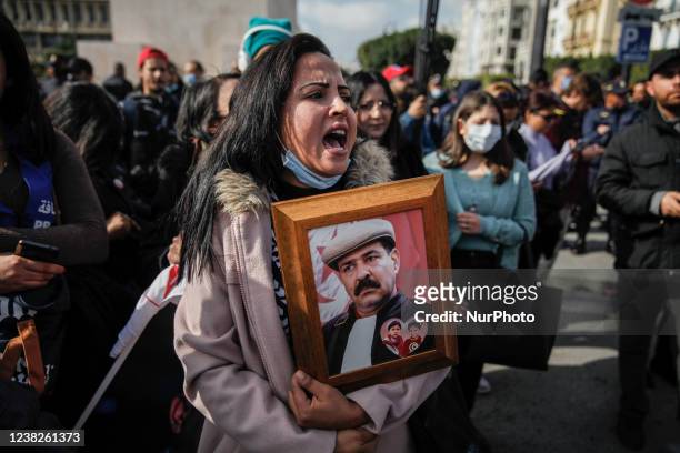 Female demonstrator holds a portrait of Chokri Belaid while shouting slogans during a demonstration held on the occasion of the 9th anniversary of...
