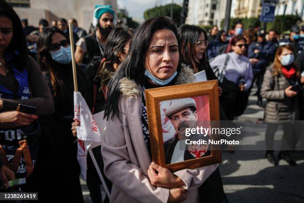 Female demonstrator holds a portrait of Chokri Belaid during a demonstration held on the occasion of the 9th anniversary of the assassination of the...