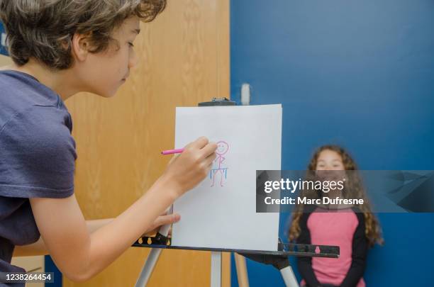 boy drawing his sister - stick figure drawing stock pictures, royalty-free photos & images