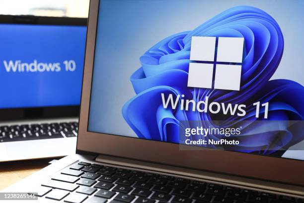 Windows 11 and Windows 10 operating system logos are displayed on laptop screens for illustration photo. Krakow, Poland on February 3, 2022.