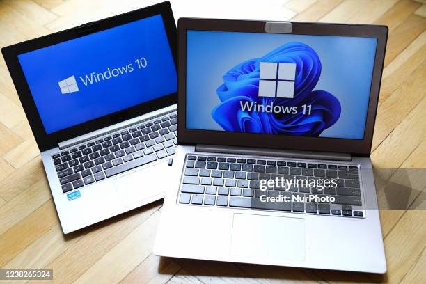 Windows 11 and Windows 10 operating system logos are displayed on laptop screens for illustration photo. Krakow, Poland on February 3, 2022.