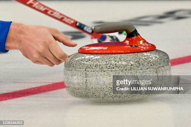 Italy's Amos Mosaner curls the stone during the mixed doubles semifinal game of the Beijing 2022 Winter Olympic Games curling competition between...