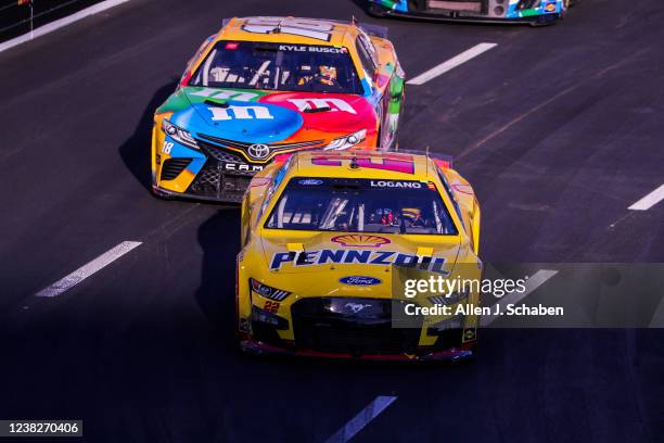 Los Angeles, CA NASCAR driver Joey Logano, #22, outraces Kyle Busch, #18, to win the Busch Light Clash At The Coliseum, a NASCAR exhibition race...