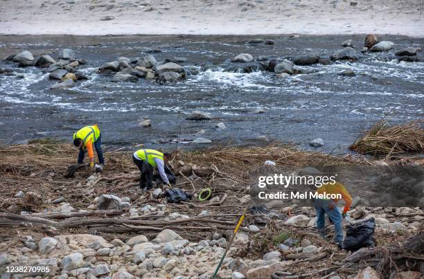 Landscapers with the City of Los Angeles pick up trash along the Los Angeles River in Los Angeles.