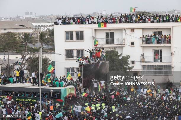 Supporters cheer the Senegalese Football teams tour in Dakar on February 7 after winning, for the first time, the Africa Cup of Nations. Senegal's...