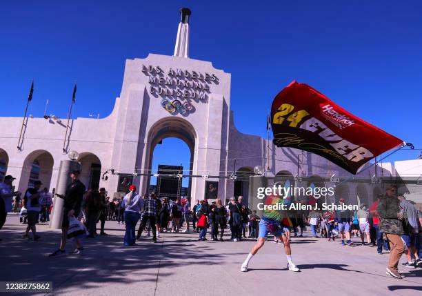 Los Angeles, CA Corvette Racing driver Jordan Taylor, dressed in costume as his alter-ego race car driver Rodney Sandstorm, waves a racing flag as...