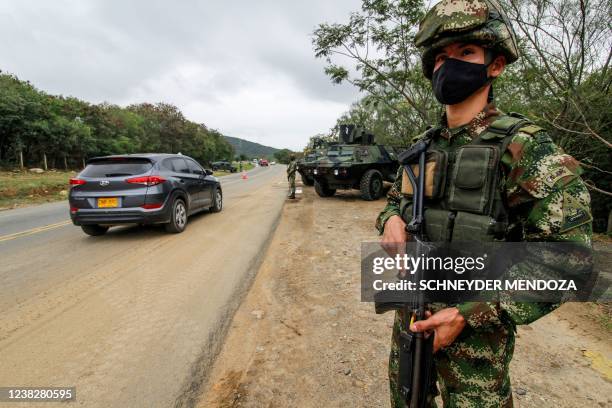 Soldiers stand guard at a check point in an avenue in Cucuta, near Venezuelan border, in Colombia on February 7, 2022.