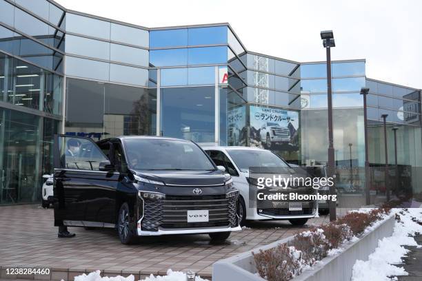 Toyota Motor Corp. Voxy minivan, left, and a Toyota Motor Corp. Noah minivan at the company's dealership in Sendai, Miyagi Prefecture, Japan, on...