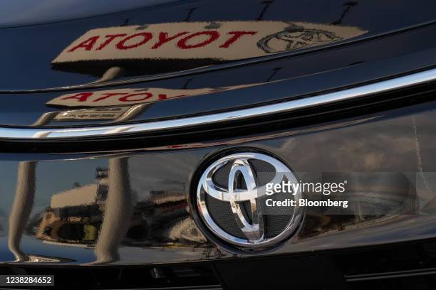 Toyota Motor Corp. Signage reflected on a Toyota Motor Corp. Minivan at the company's dealership in Sendai, Miyagi Prefecture, Japan, on Friday, Feb....