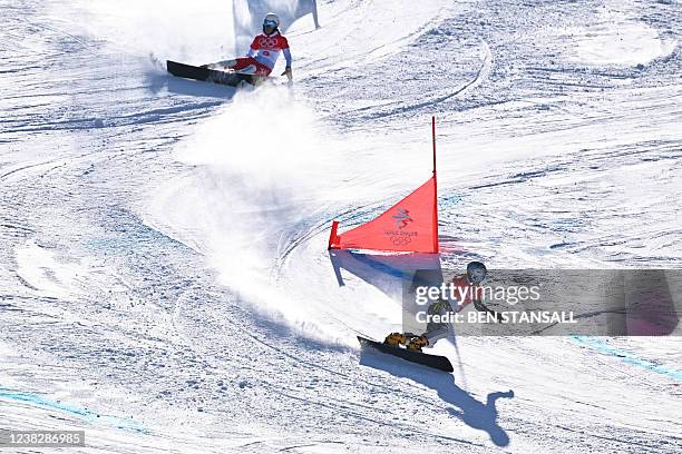 Czech Republic's Ester Ledecka and Poland's Aleksandra Krol compete in the snowboard women's parallel giant slalom quarter-finals during the Beijing...
