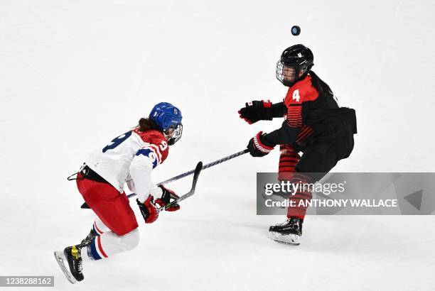 Czech Republic's Alena Mills and Japan's Ayaka Toko vie for the puck during their women's preliminary round group B match of the Beijing 2022 Winter...