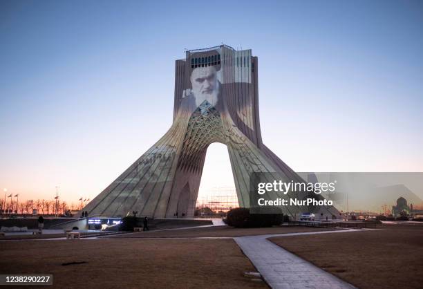 Portrait of Irans Late Leader Ayatollah Ruhollah Khomeini is pictured on the Azadi Monument in western Tehran during a video mapping to mark the 43rd...