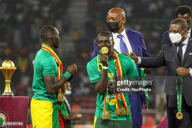 Sadio Mané of Senegal team receives his Gold medal from Patrice Motsepe, President of the Confederation of African Football after the 2021 Africa Cup...