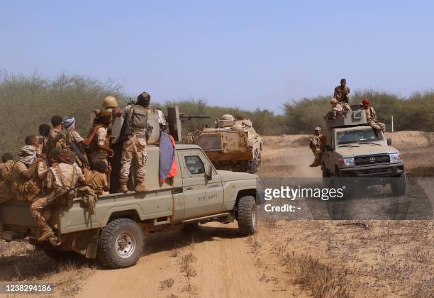 Yemeni pro-government fighters man a position near al-Muhsam camp during fighting to drive the pro-Iran Huthi rebels from the area of Harad, in...