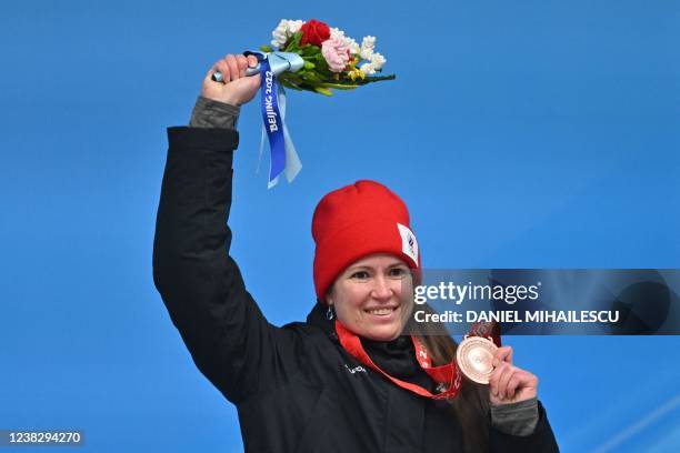 Russia's Tatyana Ivanova celebrates on the podium with her bronze medal during the venue ceremony after the women's singles luge event at the Yanqing...