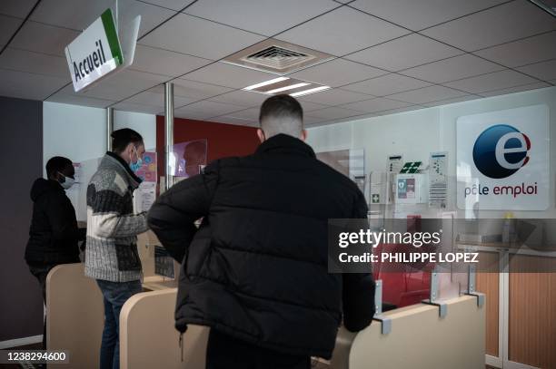 Members of the public stand at a counter of Pole Emploi "Job center" in Bordeaux, southwestern France, on February 8, 2022.