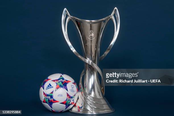 Detailed view of the UEFA Women's Champions League Knockout Stage match ball next to the UEFA Women's Champions League trophy at the UEFA...