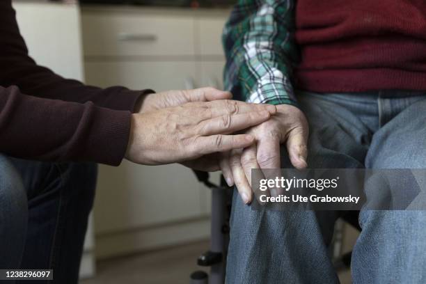 In this photo illustration father and son are touching their hands on February 05, 2022 in Heidelberg, Germany.