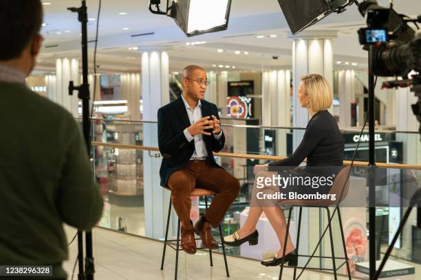 Adrian Mitchell, chief financial officer of Macy's Inc., left, speaks during a Bloomberg Television interview at the company's flagship store in New...