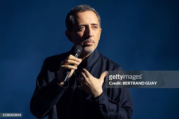 French actor and humorist Gad Elmaleh performs on stage with "D'ailleurs", his new show at Le Dome de Paris - Palais des Sports, in Paris on February...