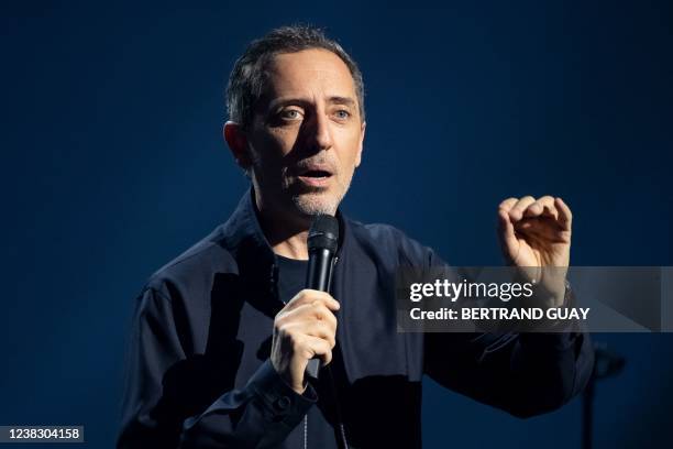 French actor and humorist Gad Elmaleh performs on stage with "D'ailleurs", his new show at Le Dome de Paris - Palais des Sports, in Paris on February...