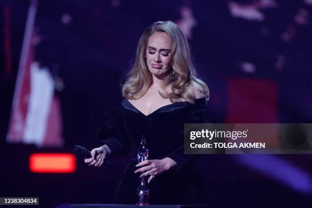 British singer Adele Laurie Blue Adkins aka Adele celebrates after receiving the album of the year award during the BRIT Awards 2022 ceremony and...