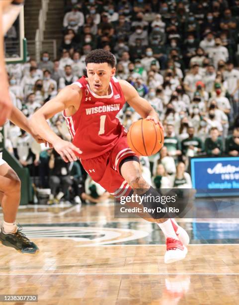 Johnny Davis of the Wisconsin Badgers drives the ball during the game against the Michigan State Spartans in the second half at Breslin Center on...